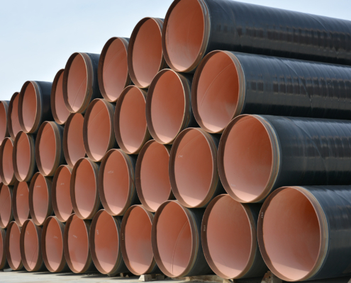 Side view of a stack of large steel pipes