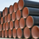 Side view of a stack of large steel pipes