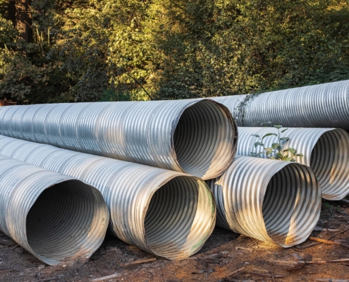 Steel culvert pipe sitting in pile on commercial property