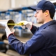 Worker measuring steel pipe